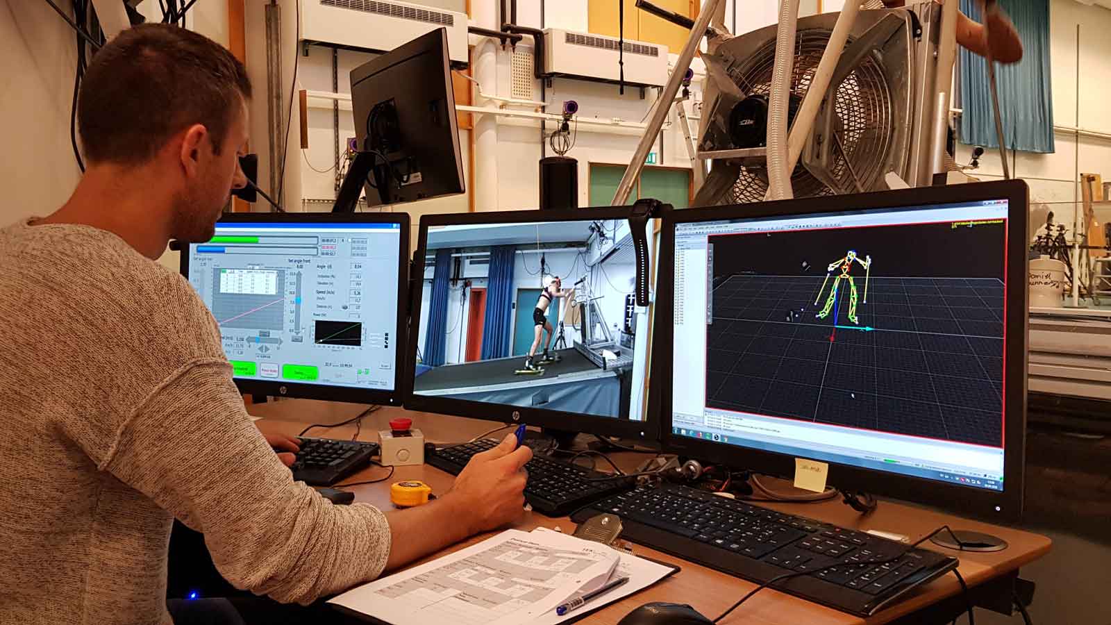 A lab engineer views different visual analyses on PC montiors