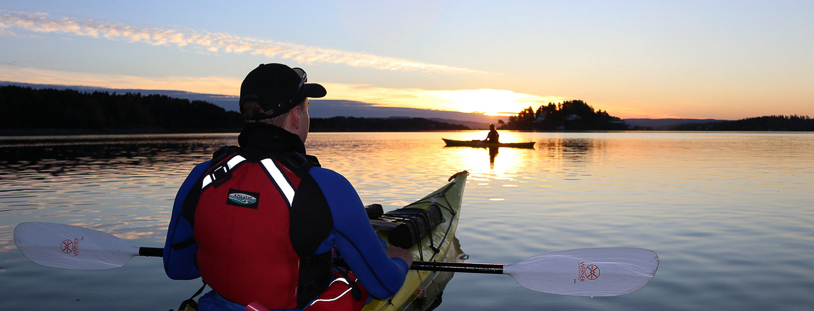 two kajaks on a lake at sunset