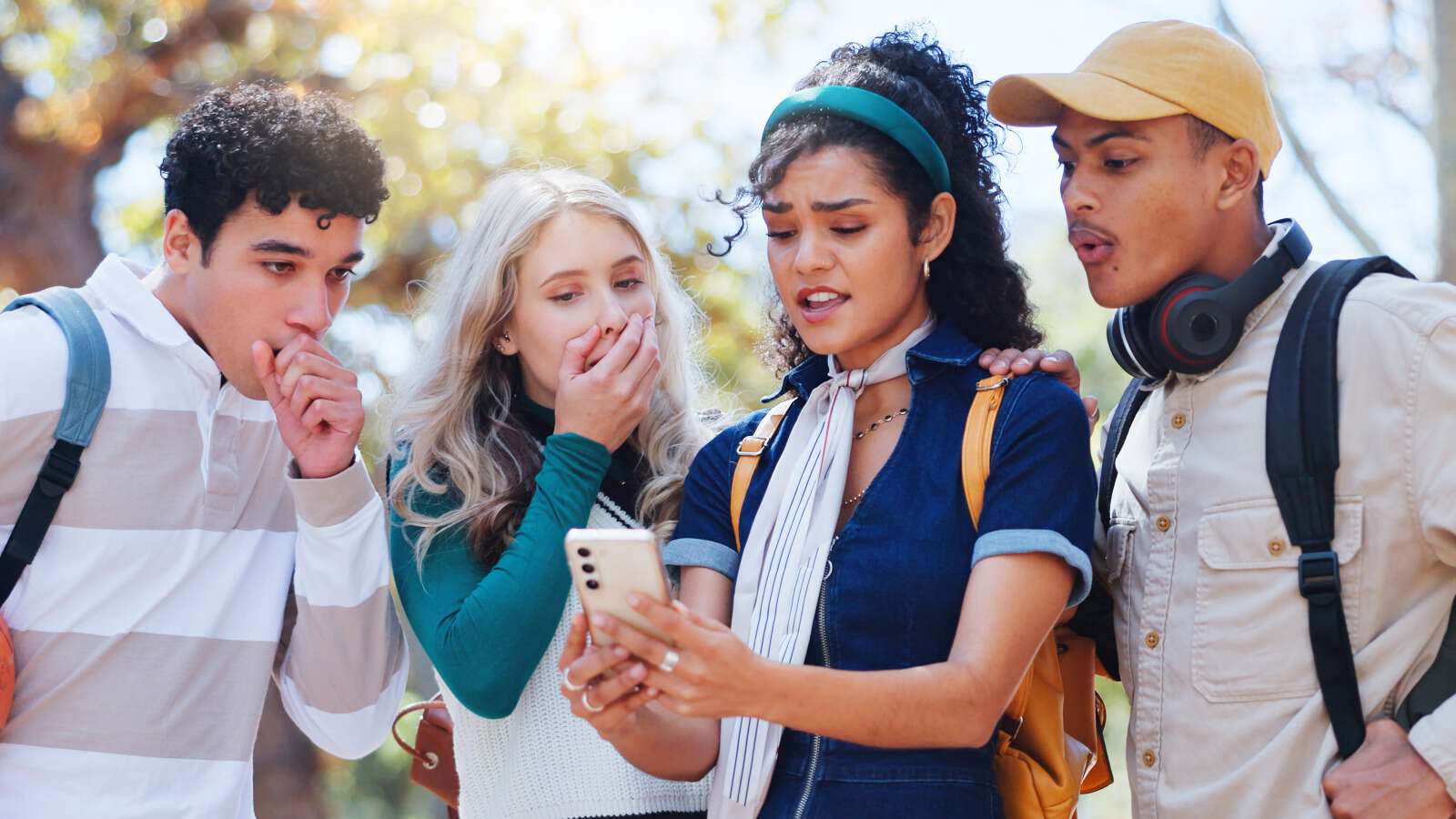 A group of friends are shocked by news on social media. 