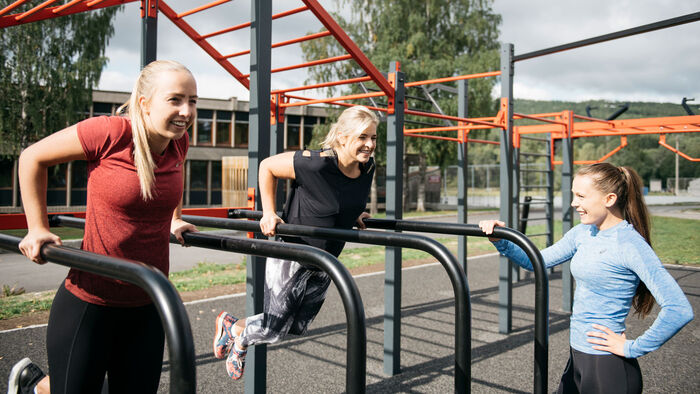 three girls do strength training outdoor