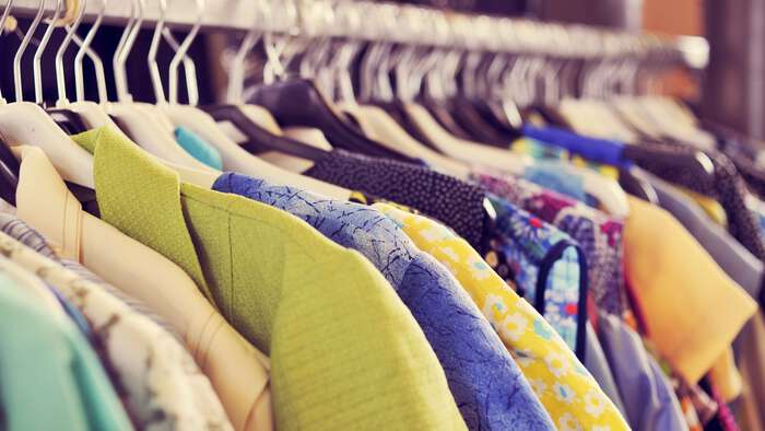 Second-hand clothes on a rack. 