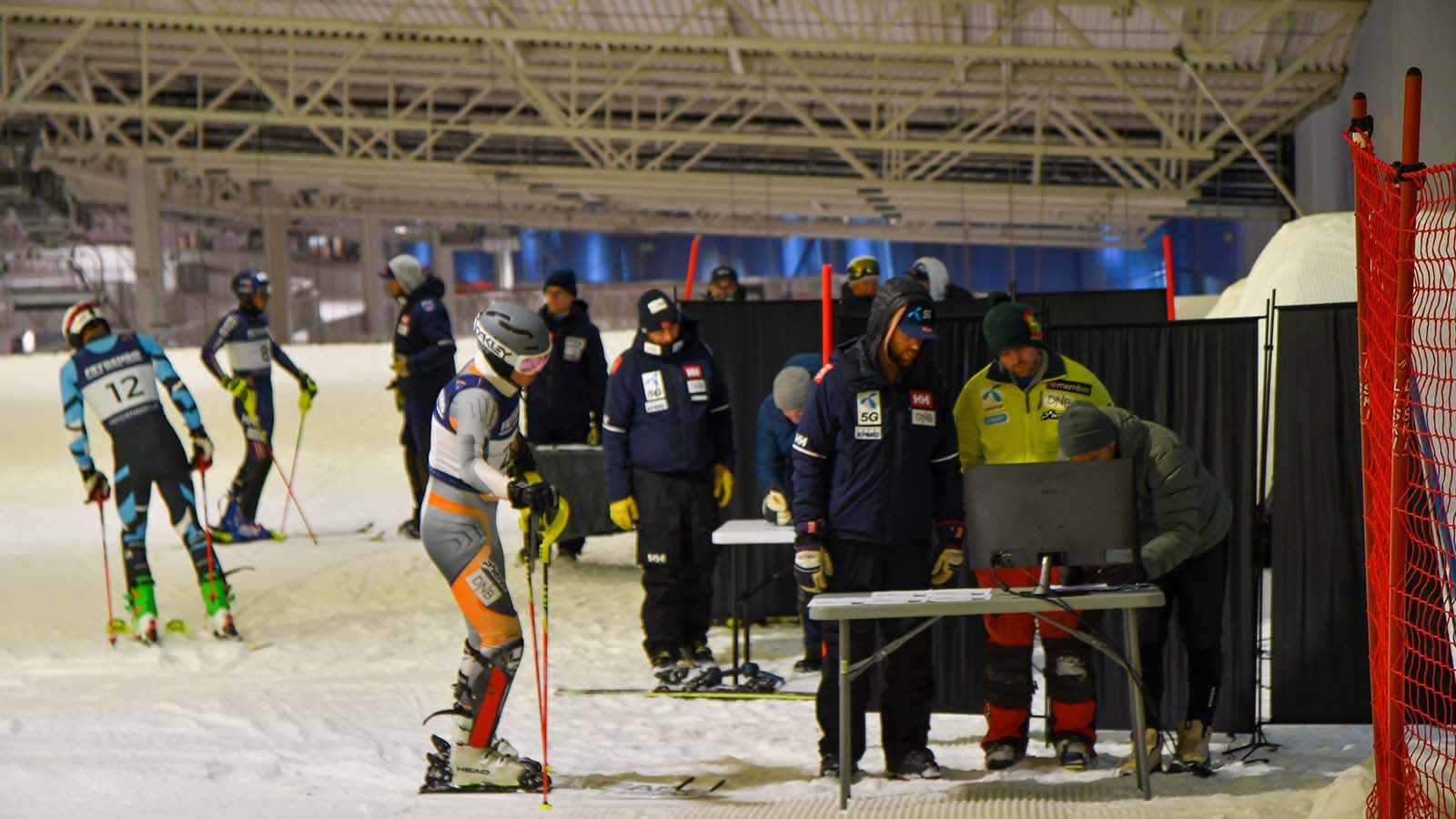 Alpine skiiers in a ski hall