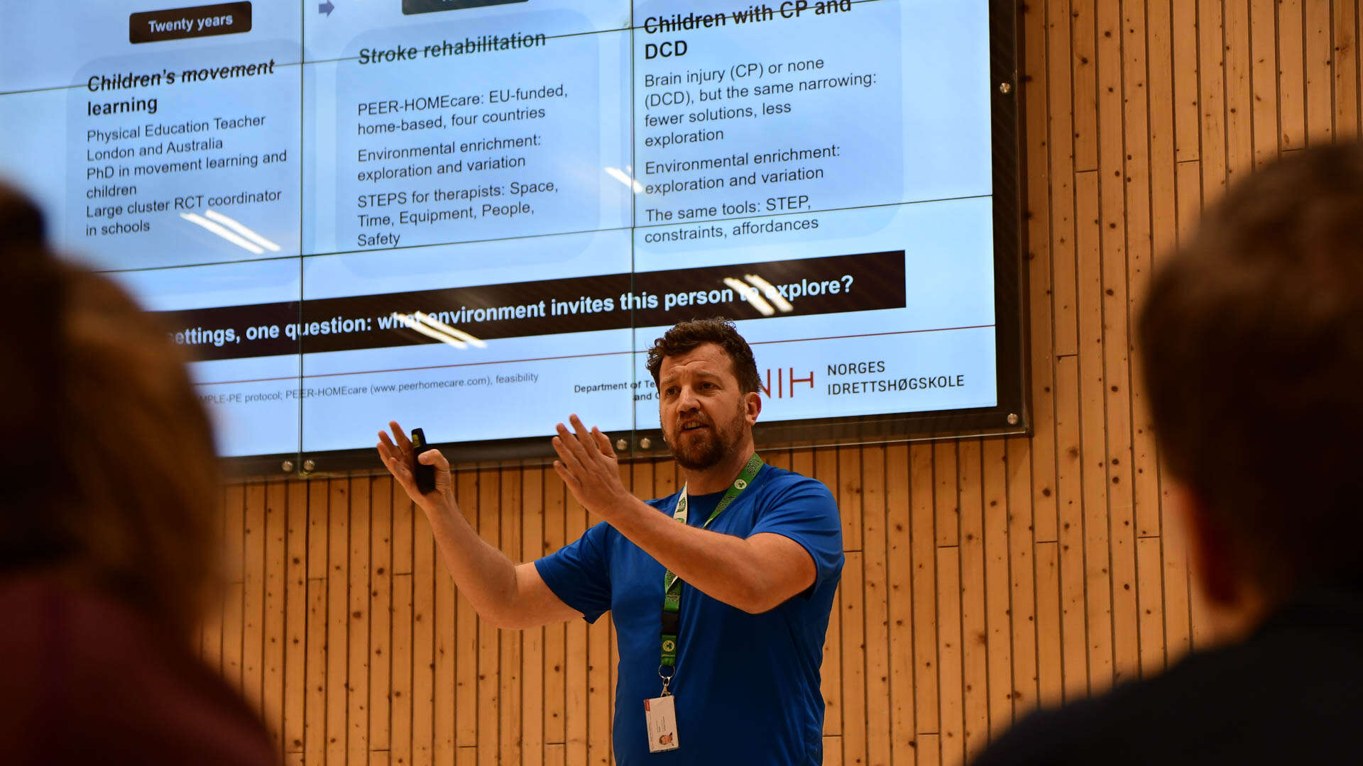 Man lecturing in front of an audience. 
