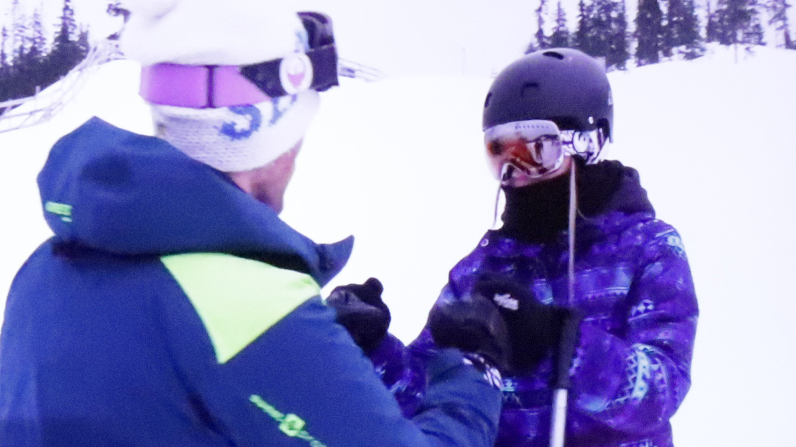 Alpine coach and young skier