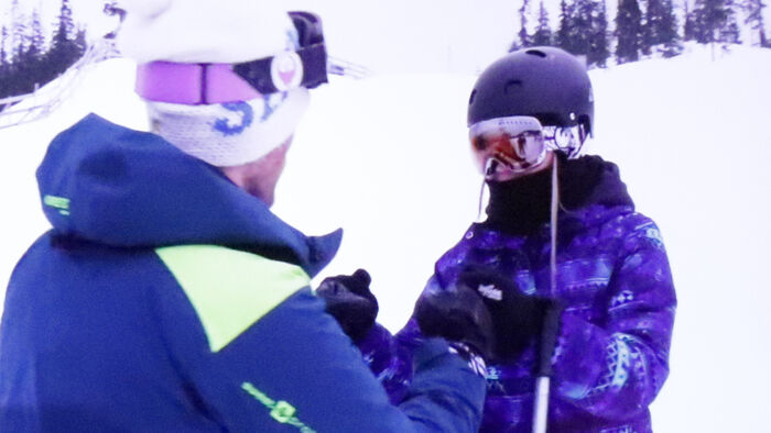 Alpine coach and young skier