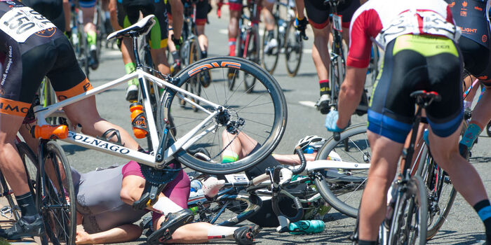 Several crashed bicycles and people