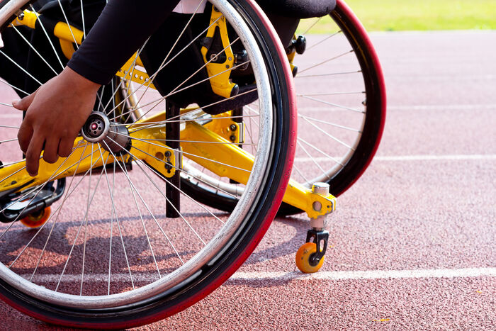 Para-athlete in a wheelchair on a racetrack