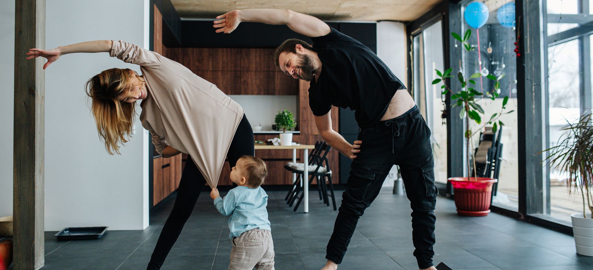 A family stretches in their living room together