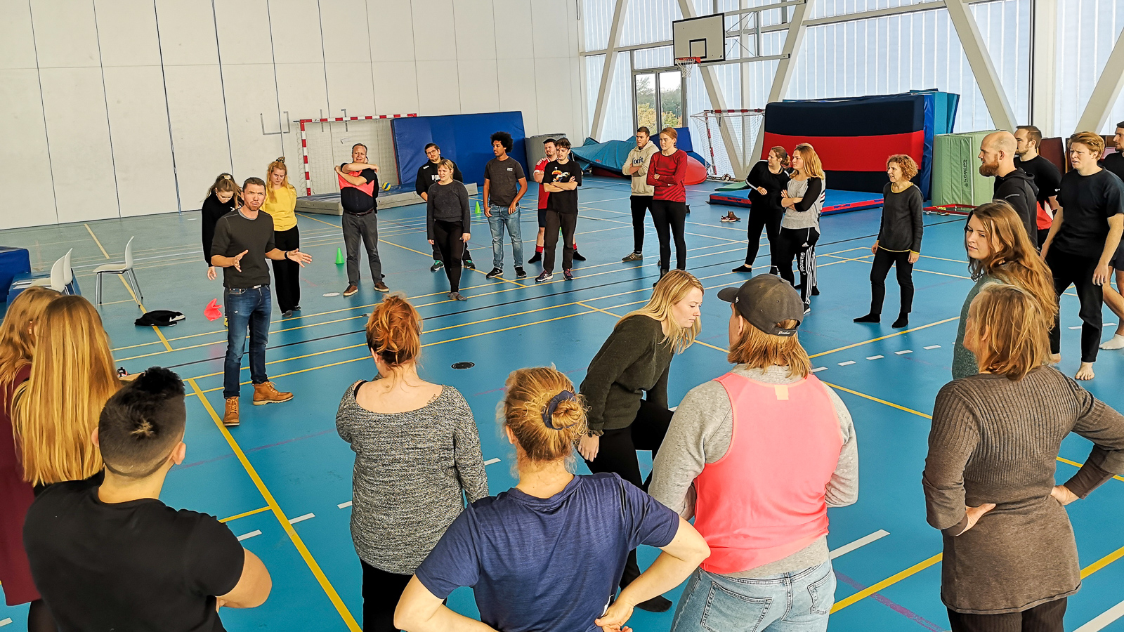Group of young people and teacher in Physical Education Hall