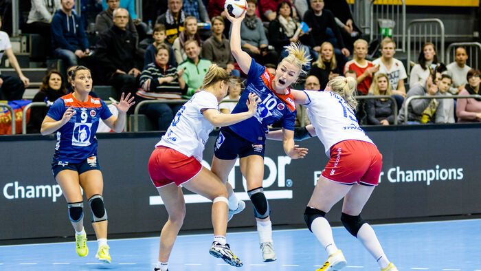 Handball match - Stine Oftedal aiming at goal ahead of two defenders