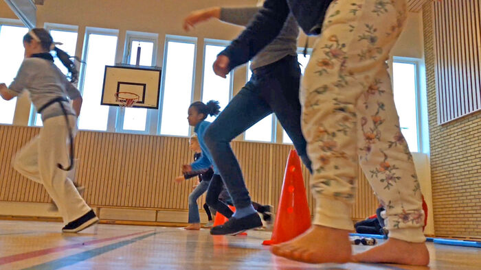 Children running in physical education, indoors